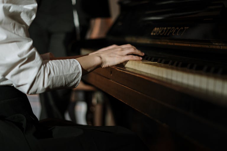 A pianist's hands gracefully playing a grand piano, evoking passion and music appreciation.